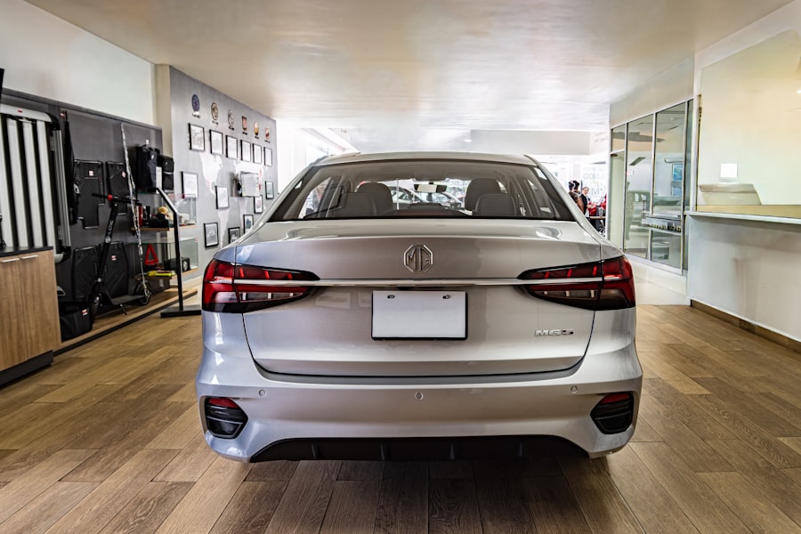 Silver sedan on a showroom floor beside the sales desks