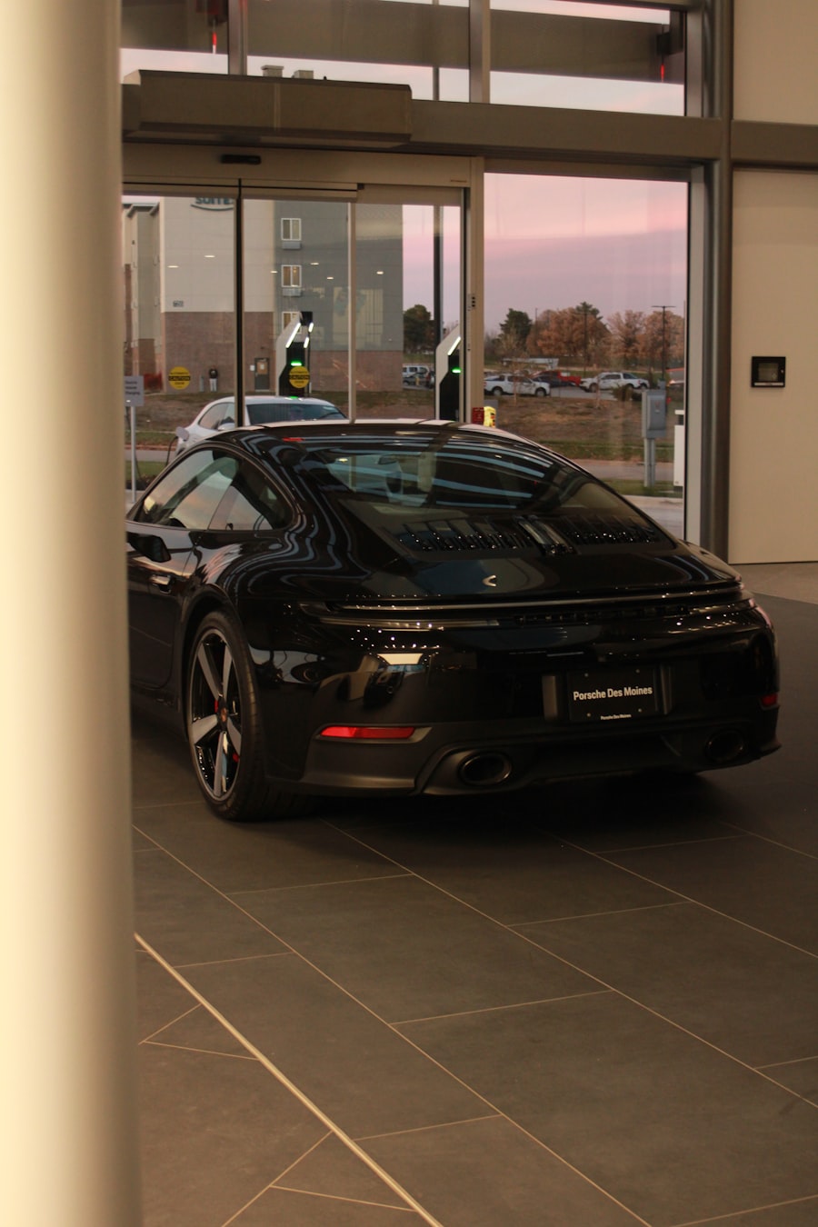 Dark sports car under showroom lighting