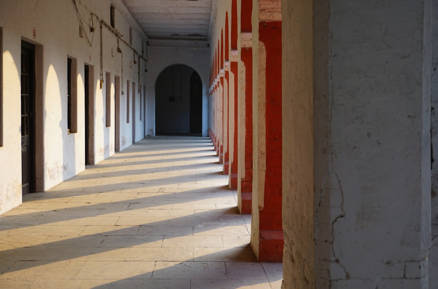 Covered walkway with red columns beside classrooms