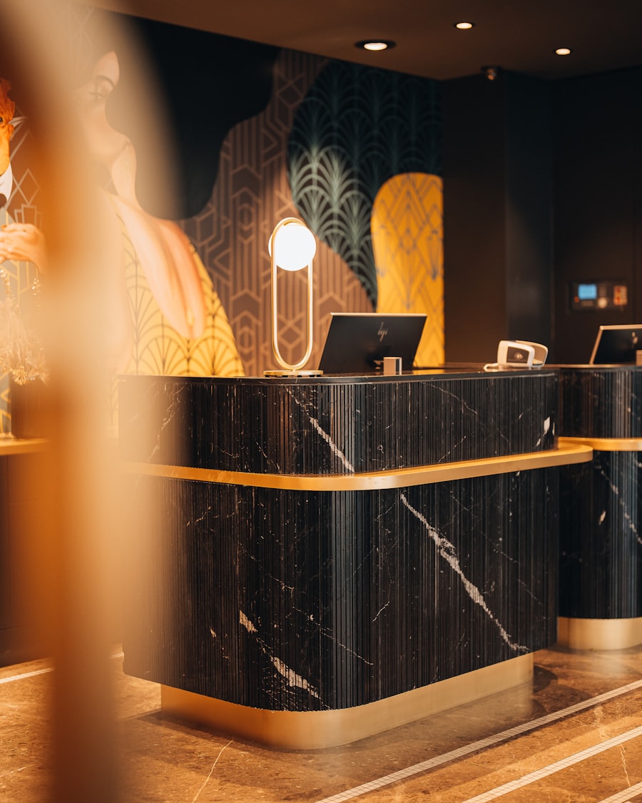 Black marble hotel reception desk with gold trim