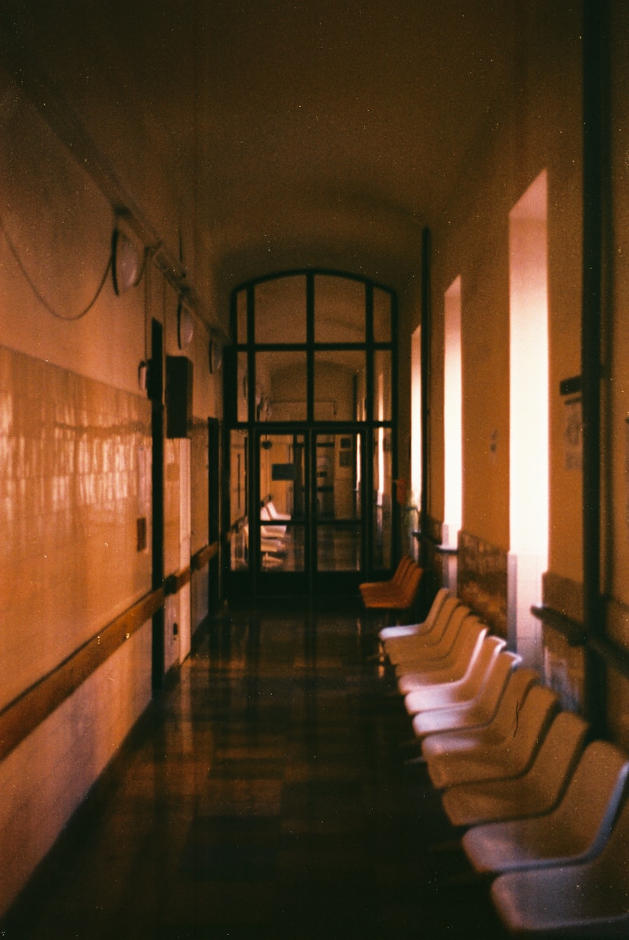 Hospital hallway with a row of waiting chairs under warm light