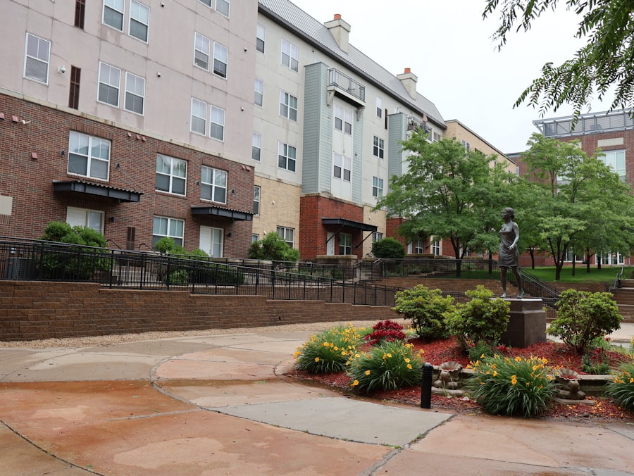 Brick apartment buildings around a paved courtyard with planters