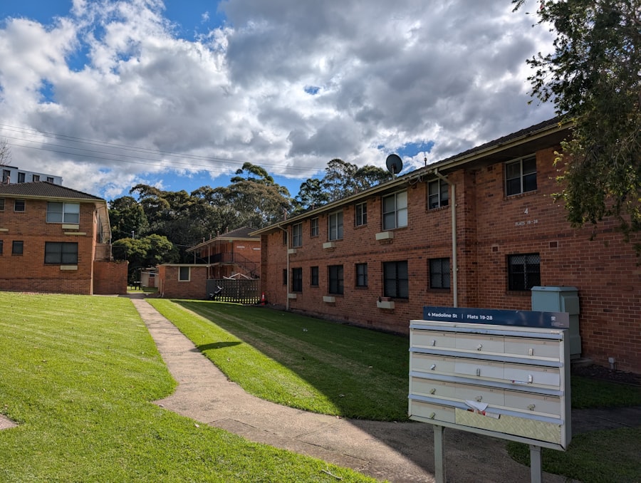 Brick apartment buildings beside a mowed lawn and walkway