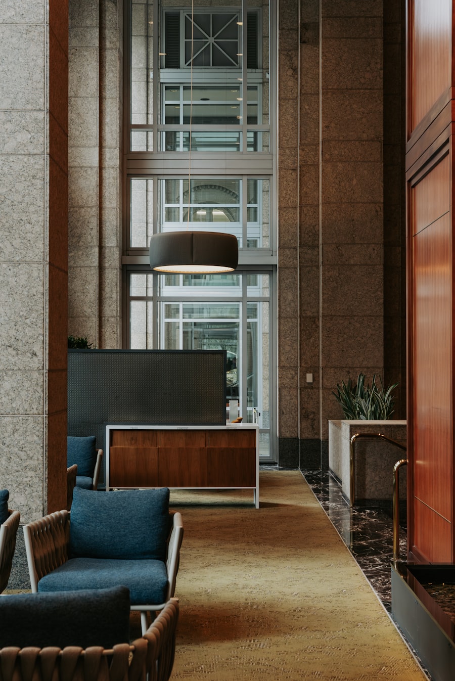 Lobby lounge with leather chairs beside tall windows