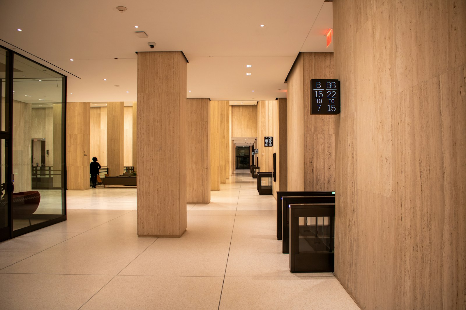 Commercial lobby with stone pillars and an elevator bank