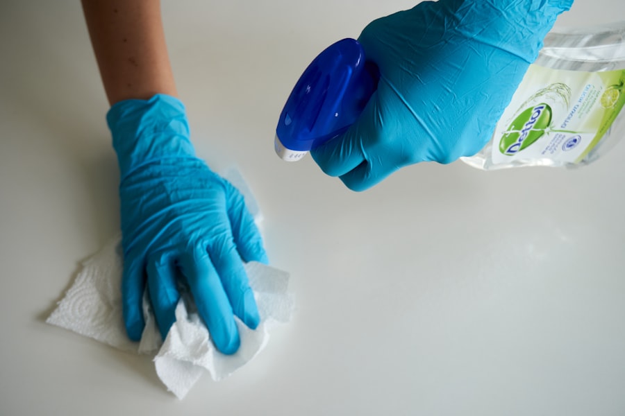Gloved hand wiping a counter with a paper towel