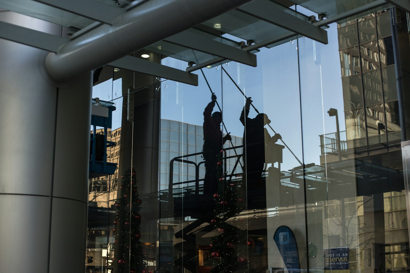 Window cleaners working on the glass facade of an office tower