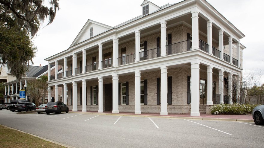 Two-story columned building housing Port City Plastic Surgery